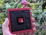 Eine Person hält einen Qualcomm Snapdragon 8 Elite Gen 5 Chip, umgeben von Grün.