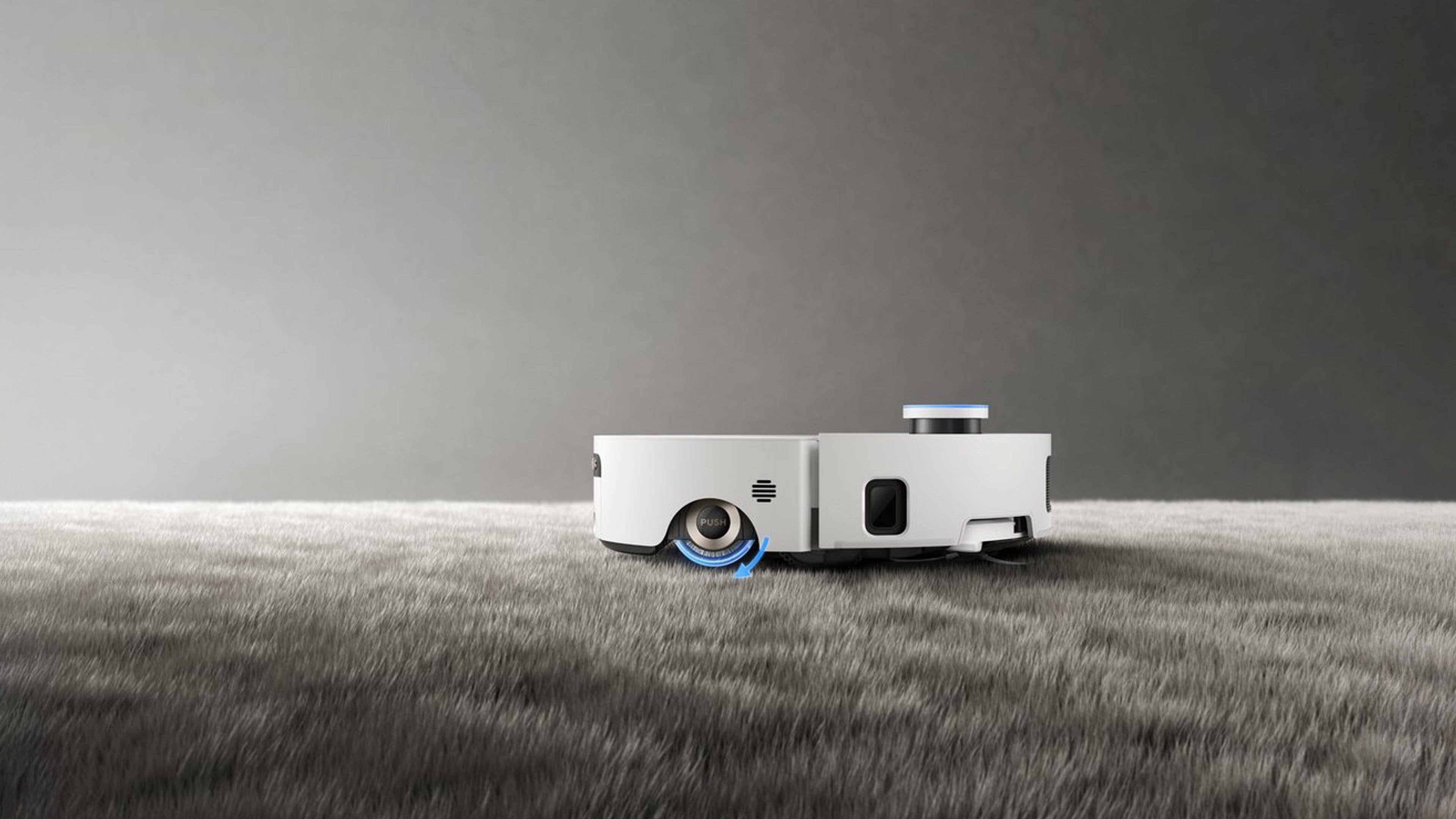 Ein weißer Roboterstaubsauger, der Dreame Aqua10 Roller Complete, auf einer weichen, strukturierten Oberfläche.