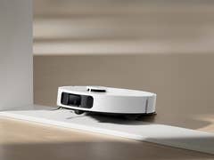 Ein Dreame L10s Ultra Gen 2 Saugroboter auf einem glatten Boden in der Nähe einer Wand.