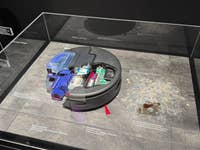 Präsentation des Dyson Spot+Scrub Ai, die seine internen Komponenten und Reinigungseigenschaften zeigt.