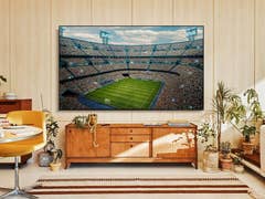 Ein Samsung Smart TV zeigt ein Fußballspiel in einem Wohnzimmer.