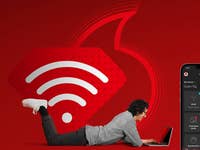 Vodafone-Logo und WLAN-Symbol plus Vodafone App und ein Notebook-Nutzer