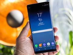 Eine Person hält ein Samsung Galaxy Note 8 Smartphone, das Wetterinformationen anzeigt.
