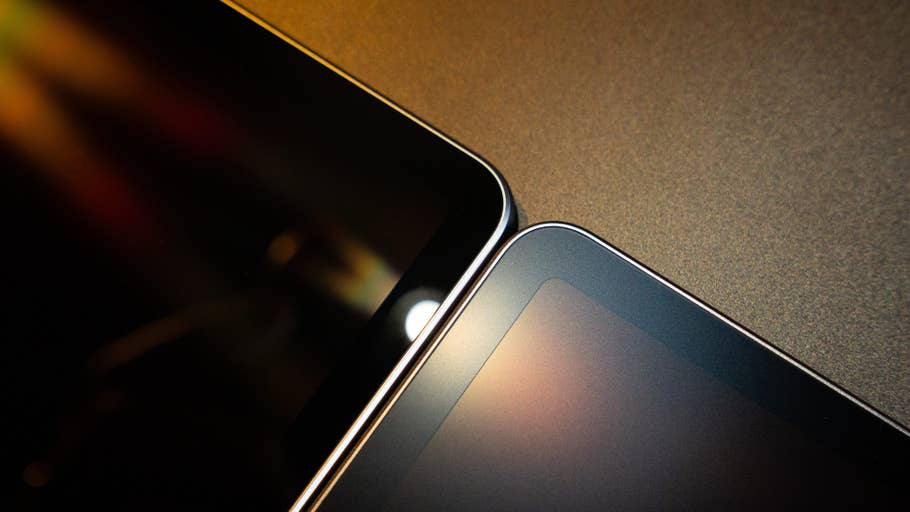 Nahaufnahme von zwei überlappenden Tablets auf einer strukturierten Oberfläche.