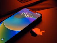 Ein iPhone 13 neben iPad und Mac