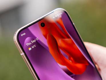 Nahaufnahme einer Hand, die ein Google Pixel 9 Pro-Smartphone hält, das das Datum und das Wetter anzeigt.