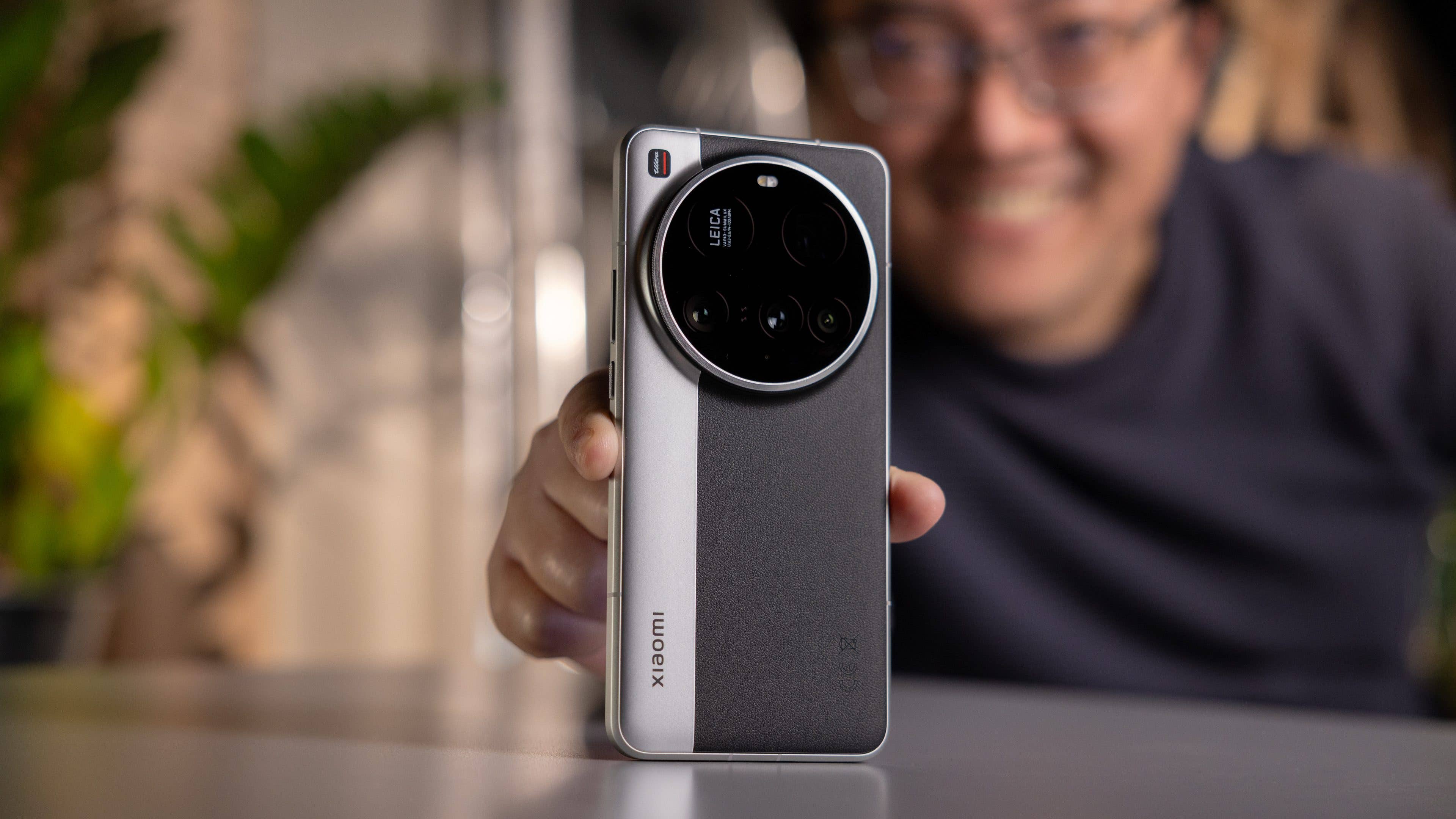 Eine Person hält ein Xiaomi 15 Ultra-Smartphone und lächelt mit grünem Hintergrund. Eine Person hält ein Xiaomi 15 Ultra-Smartphone und lächelt mit grünem Hintergrund.