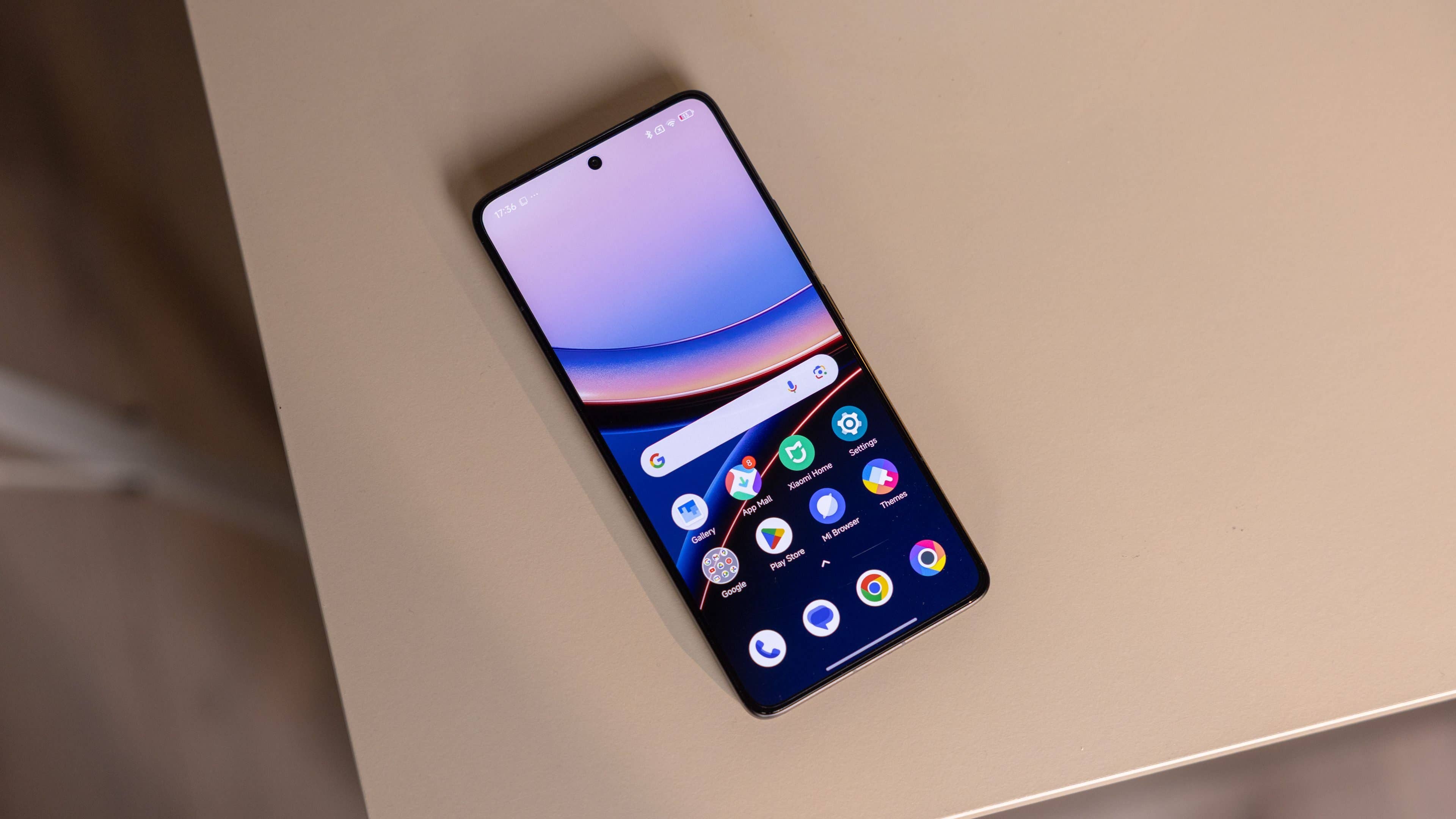 A Poco F7 Ultra smartphone shows a colorful home screen against a beige surface.